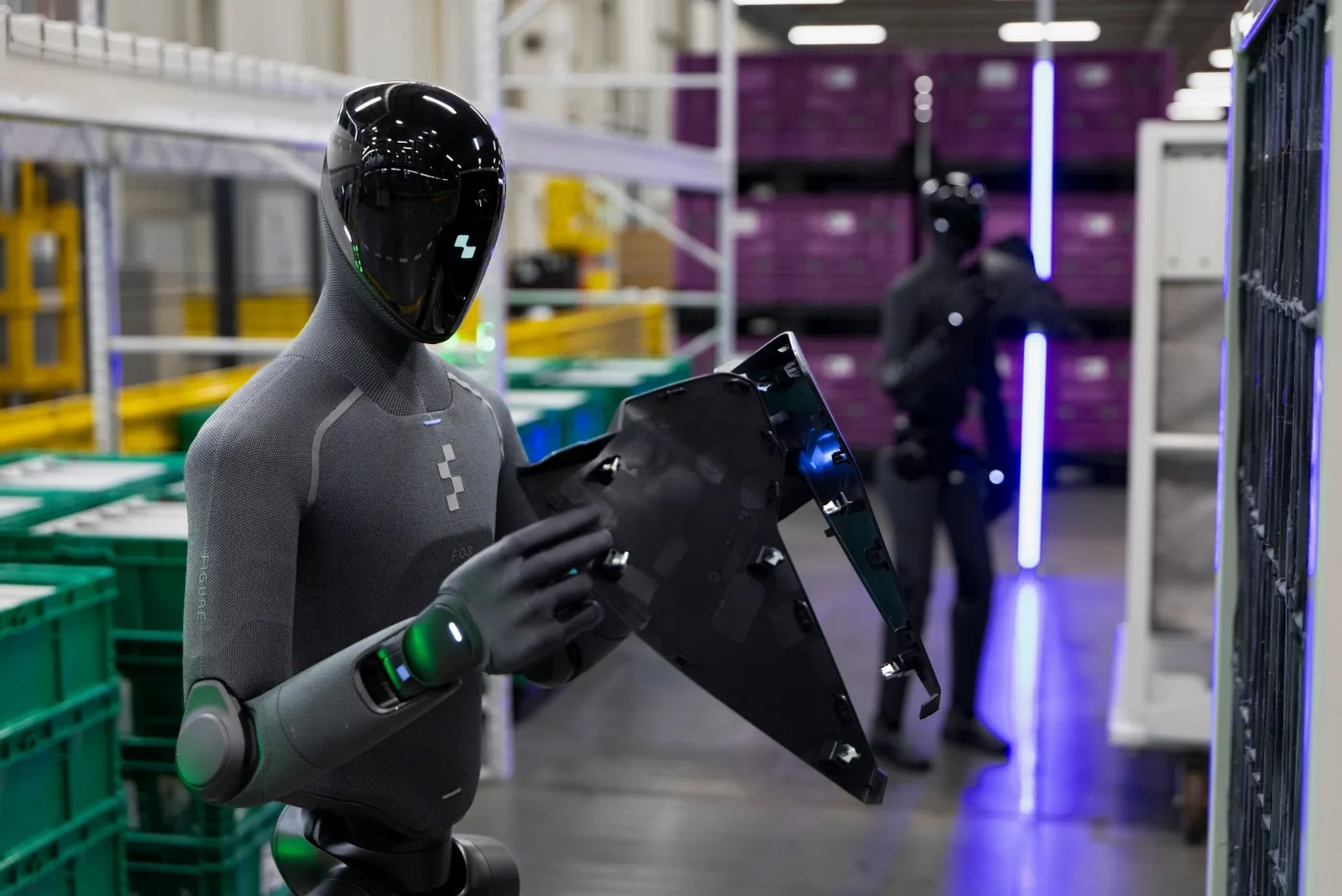 Two Figure 03 humanoid robots handling automotive parts at BMW Plant Spartanburg