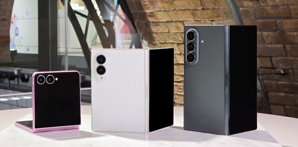 Samsung Galaxy Z Flip8, Galaxy Z Fold8 in white and Galaxy Z Fold8 Ultra in gray standing half-folded on a table